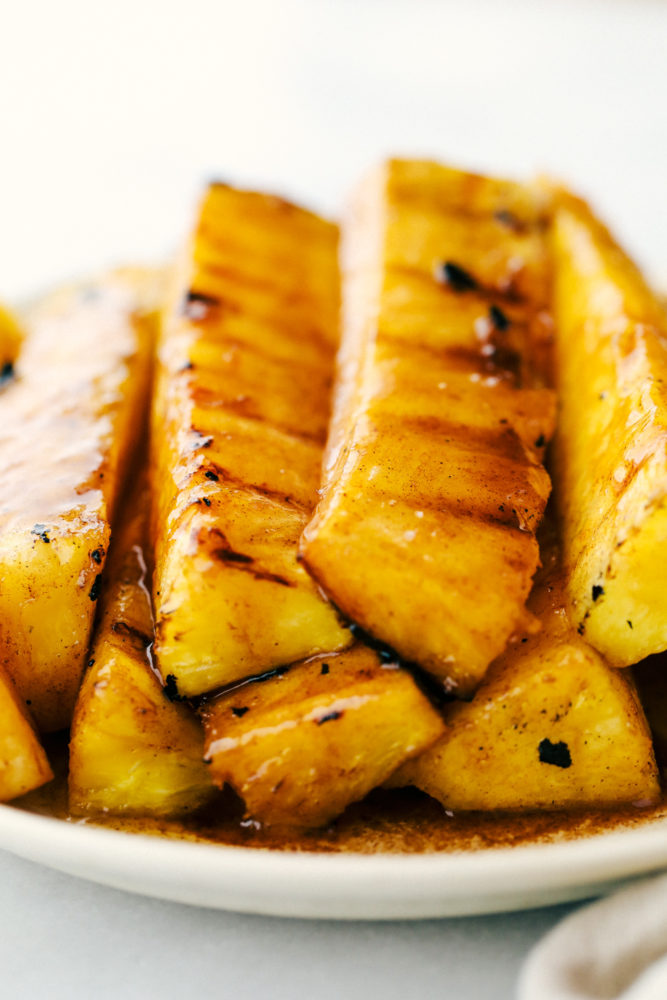 Pineapple stacked on top of each other on a white plate. 