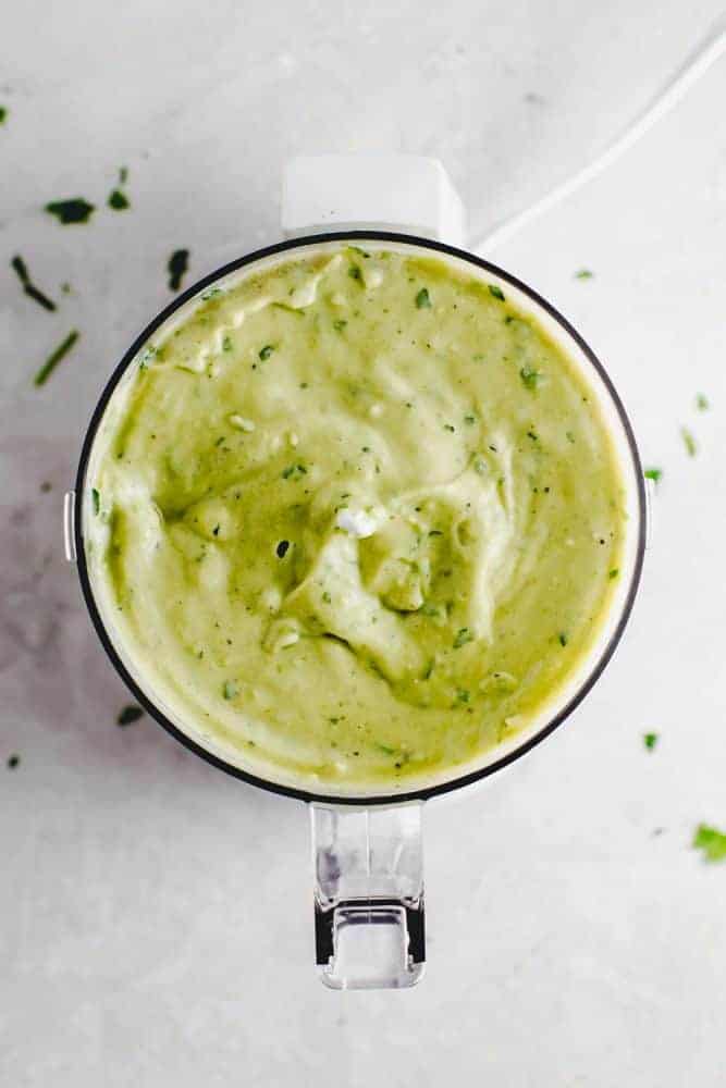 Avocado cream sauce being blended together. 