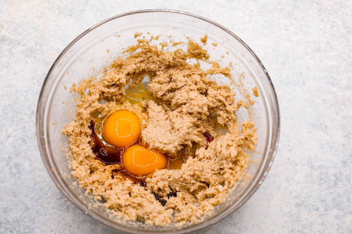 Overhead shot of butter and sugar mixture with eggs and vanilla. 