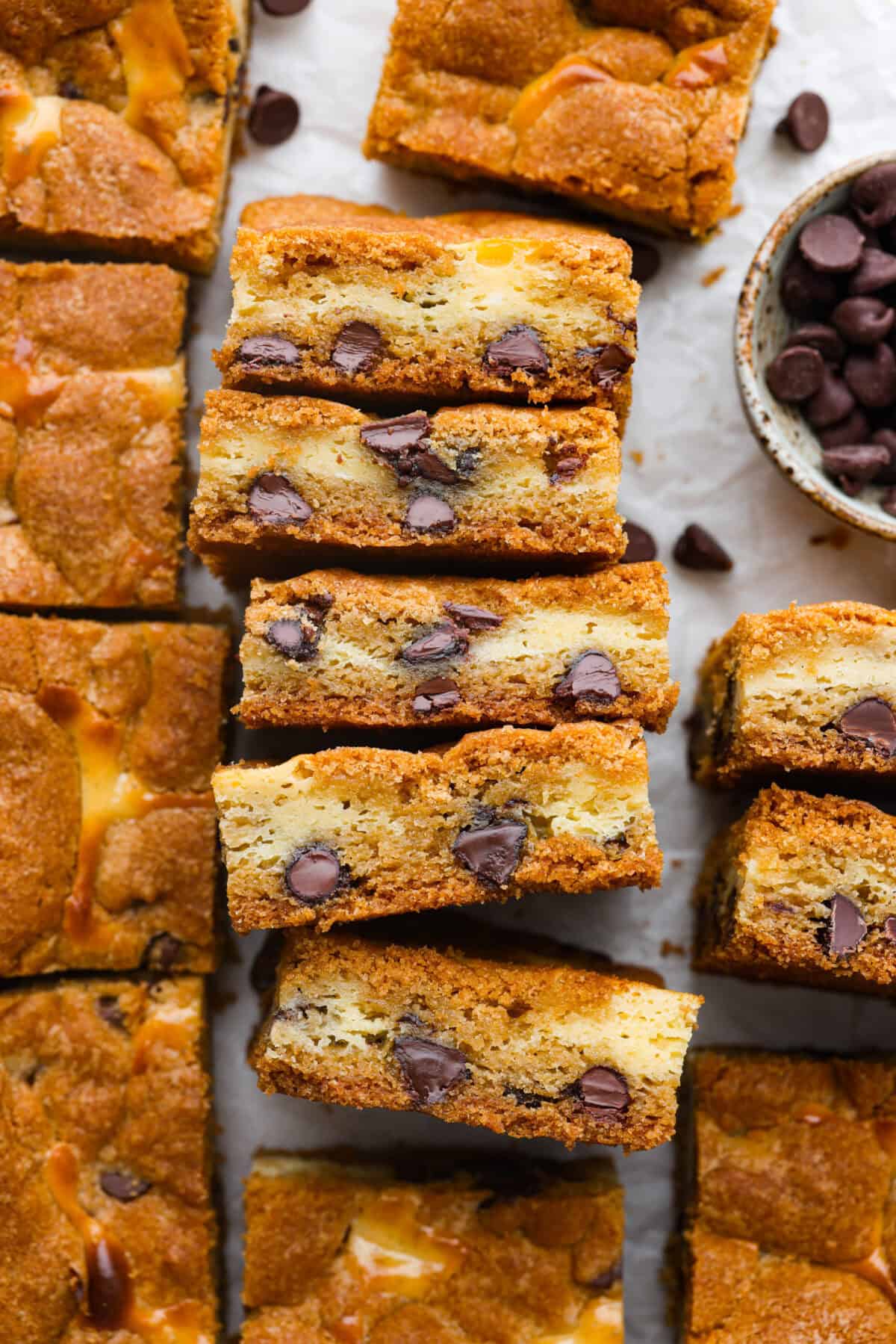 Overhead shot of chocolate chip cheesecake brownies cut and placed on their side. 