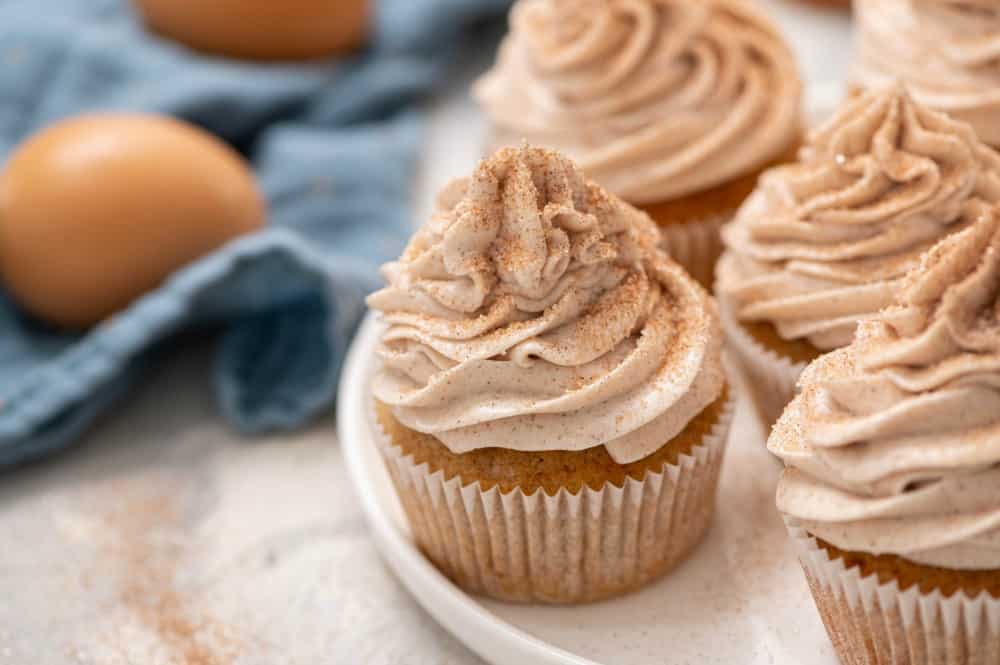 Churro cupcakes on a white plate. 