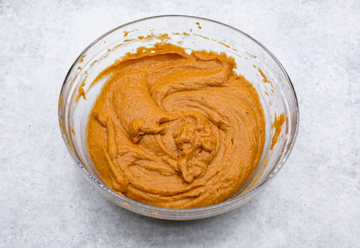 Overhead shot of wet and dry ingredients mixed together in a bowl. 