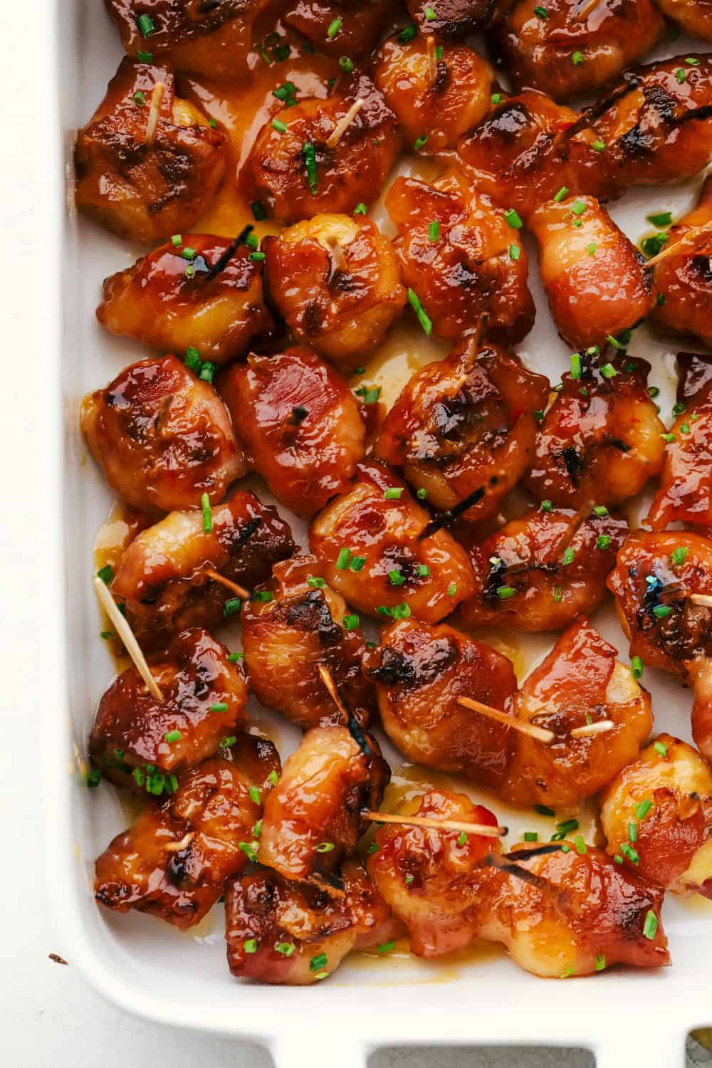 Savory bacon wraps crunchy chestnuts in a sweet spicy sauce.