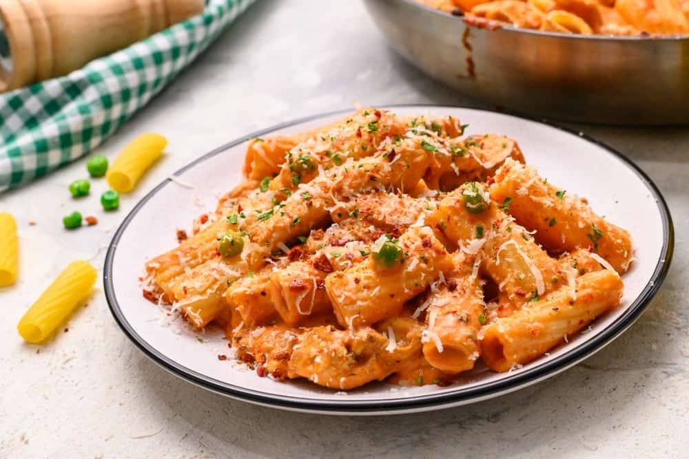 Spicy chicken rigatoni on a white plate. 