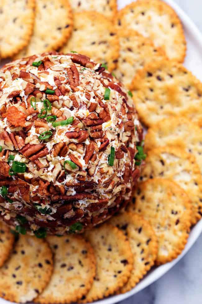 Top close view of bacon ranch cheese ball on a plate with crackers.