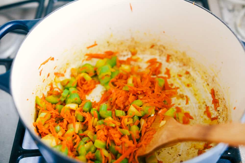 vegetable being sautéed together in a pot over the stovetop. 