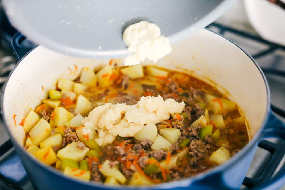 Adding in the roux to the soup. 