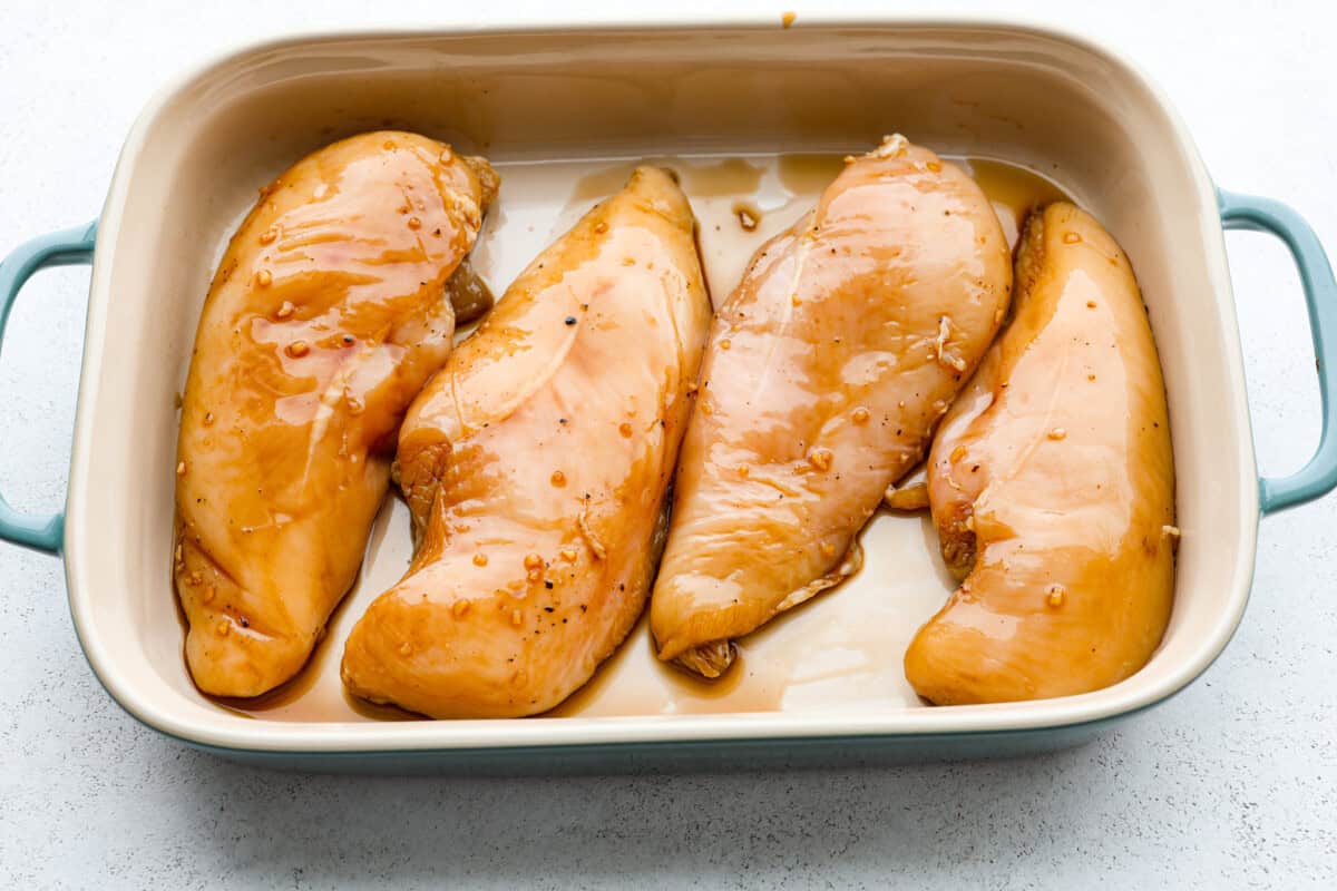 Overhead shot of marinated chicken in a baking dish. 