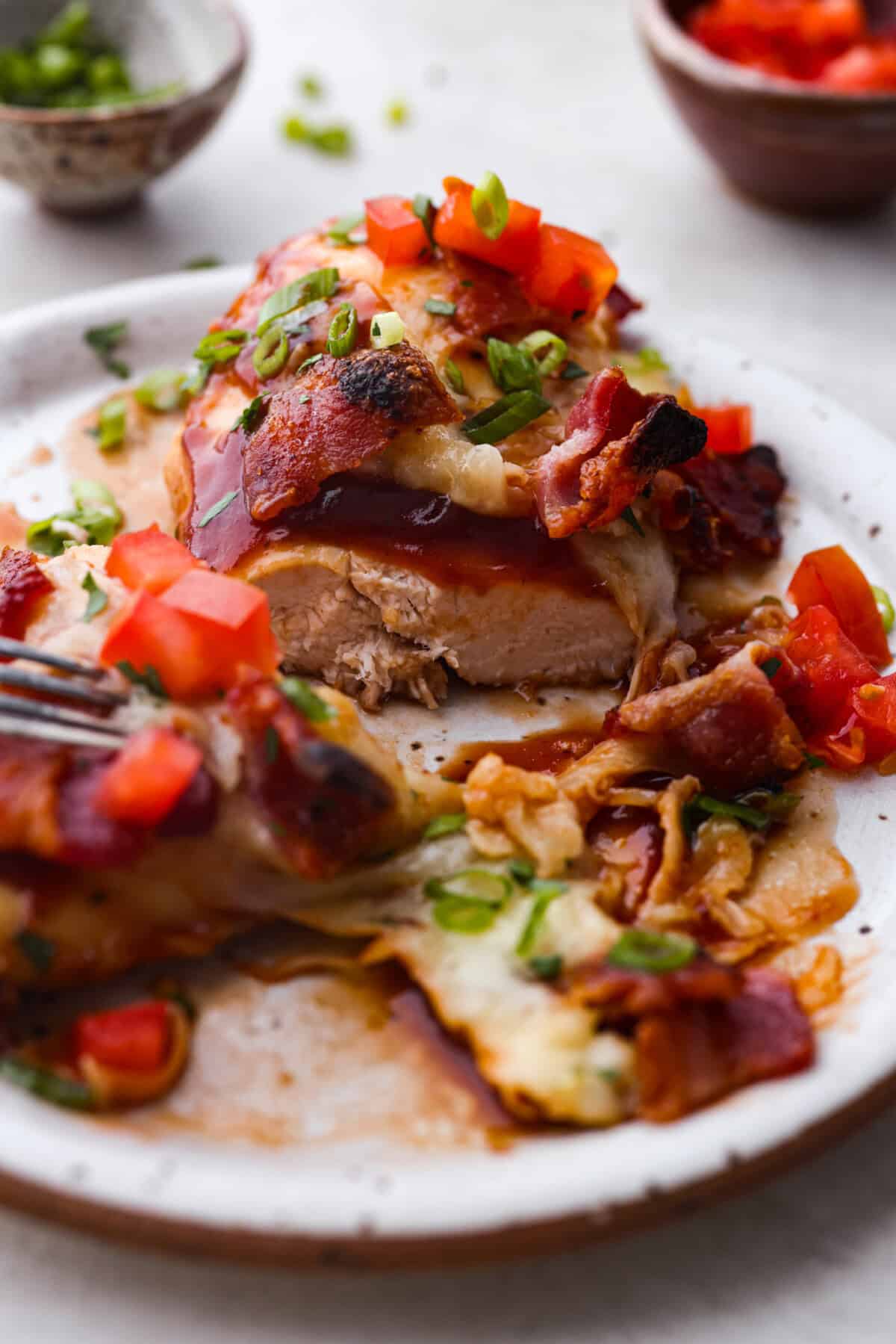 Side shot of plated Monterey chicken cut in half. 