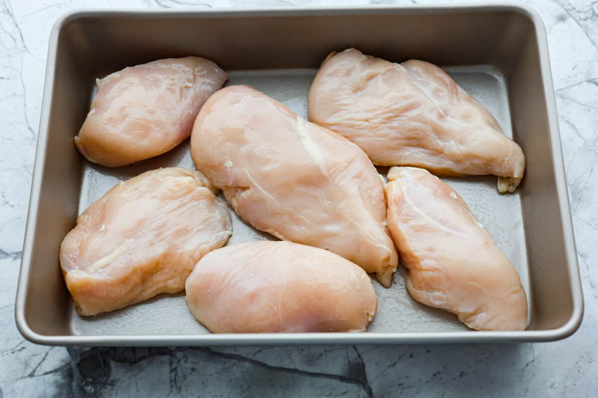 Overhead shot of chicken breasts in a 9x13 pan. 