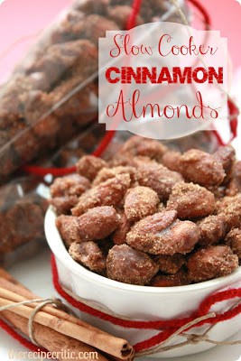 Slow cooker cinnamon almonds in a white bowl.