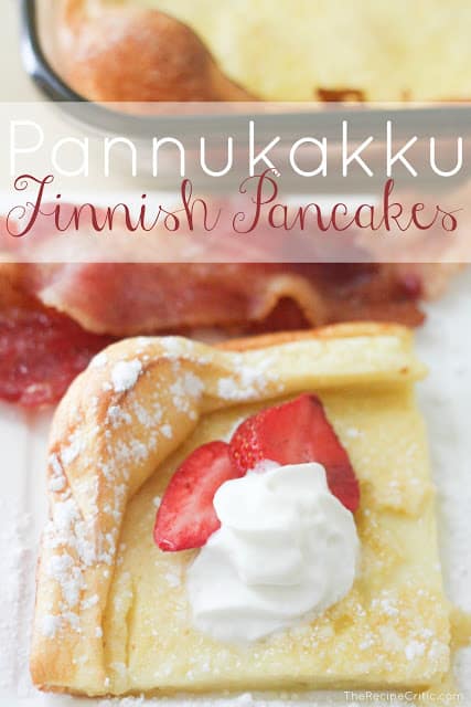 A Pannukakku Finnish pancake garnished with whipped creame and two slices of strawberries with bacon on the side.