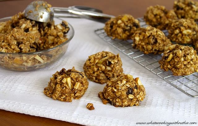 Healthy Oatmeal Apple Raisin Cookies on cooling sheet and in a glass bowl.