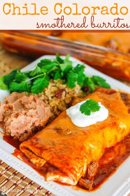 Chile Colorado Smothered Burritos with beans and rice on white plate