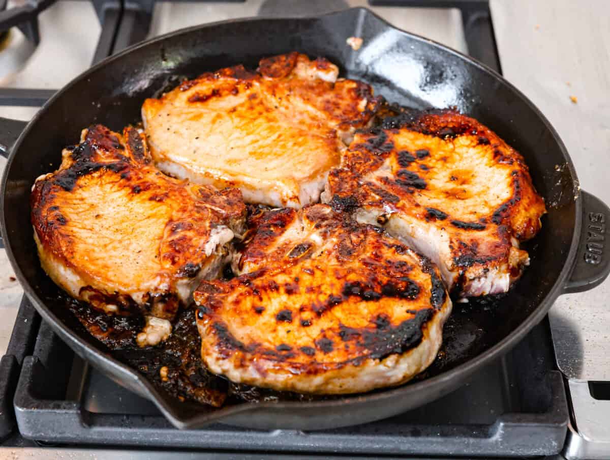 Overhead shot of pork seared in a skillet. 