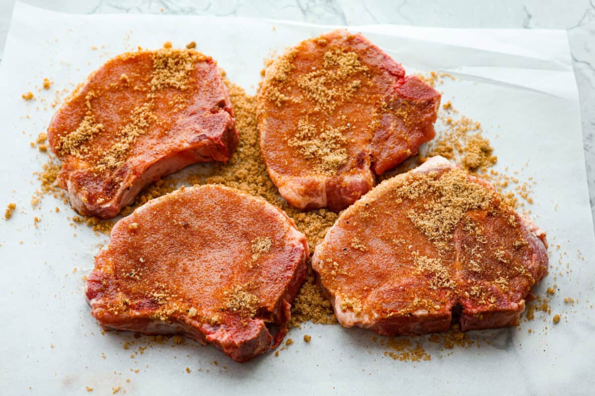 Overhead shot of pork chops covered in brown sugar glaze rub. 