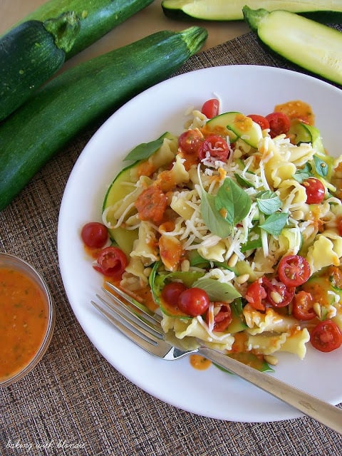 Garden Campanelle Salad with Fresh Tomato Basil Dressing on a white plate.