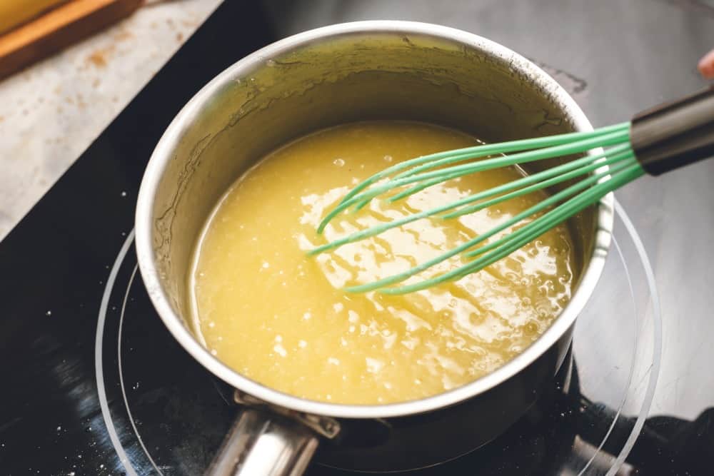 Making the cream cheese glaze to drizzle over the cinnamon roll pancakes. 