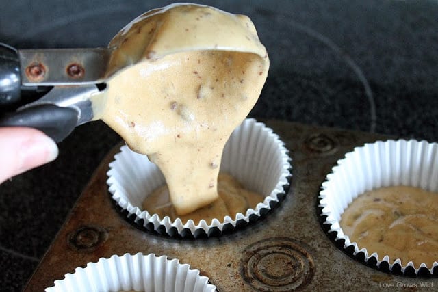 Cappuccino and Chocolate Cupcakes batter being poured into cupcake papers in a pan.