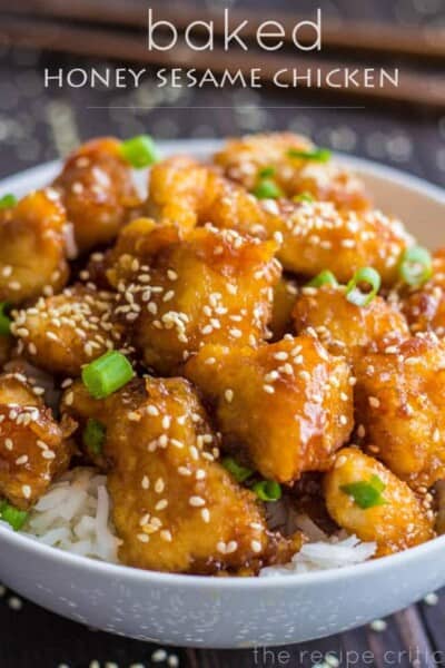 Baked Honey Sesame Chicken over white rice in a white bowl. 