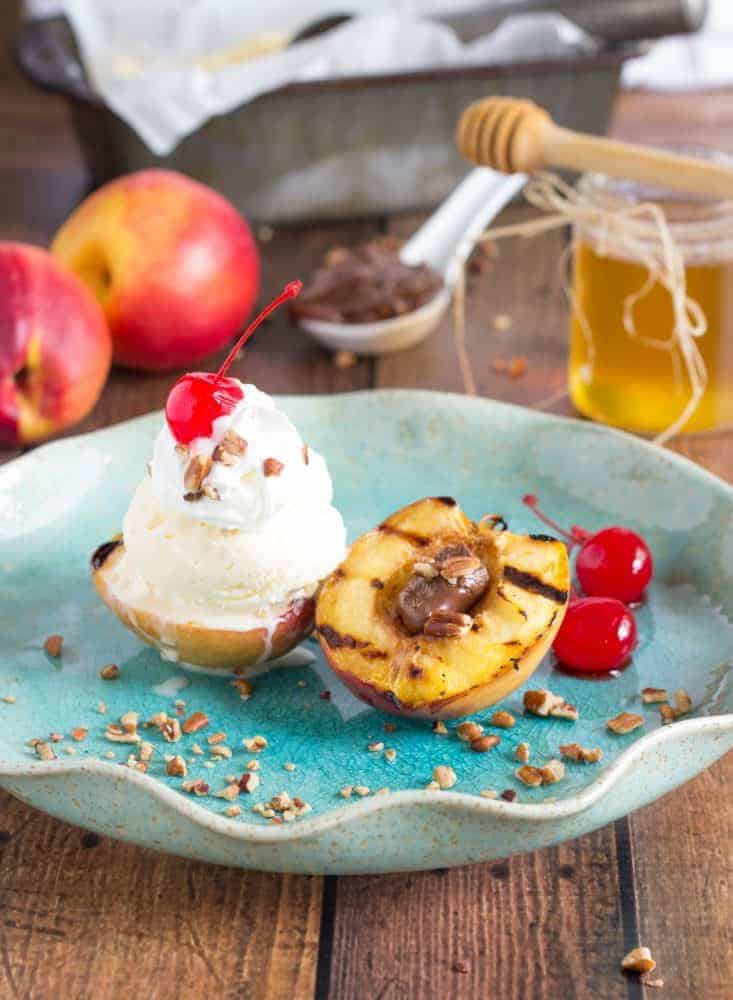 Grilled Nectarine Sundae on a blue plate on a wooden table. 