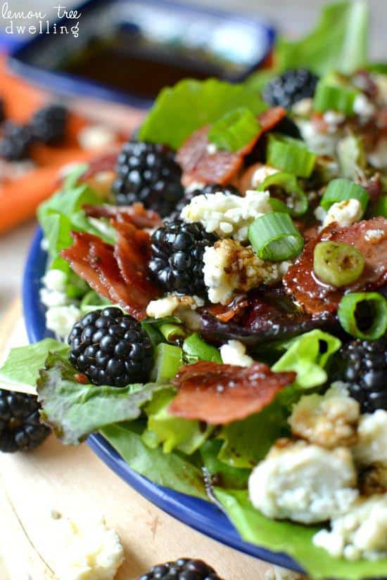 Close up of Blackberry, Bacon & Blue Cheese Salad in a blue bowl. 