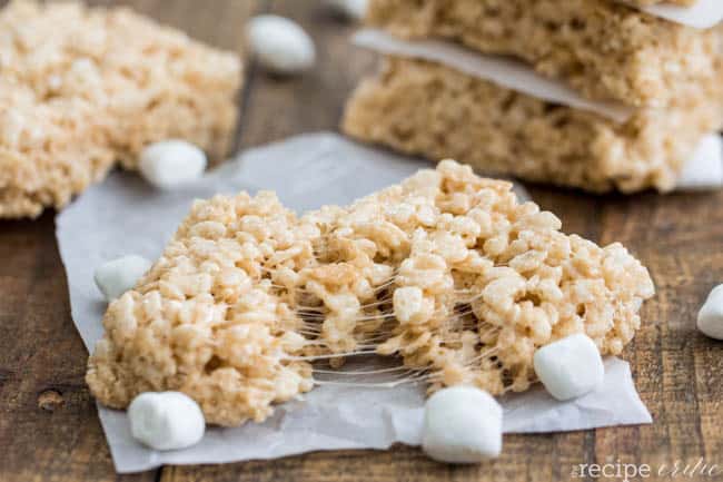 Brown butter Rice Krispie treats being split apart. 