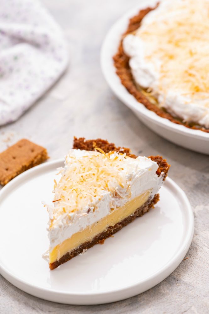 Slice of key lime pie on a white plate.