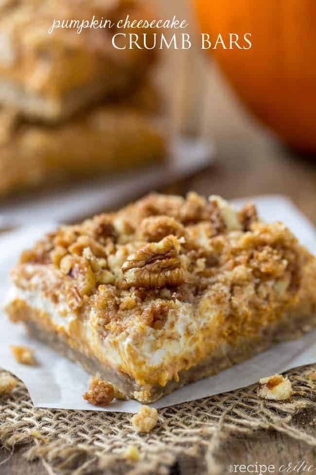 Pumpkin cheesecake crumb bar on a parchment paper. 