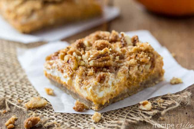 Pumpkin cheesecake bar on a parchment paper. 