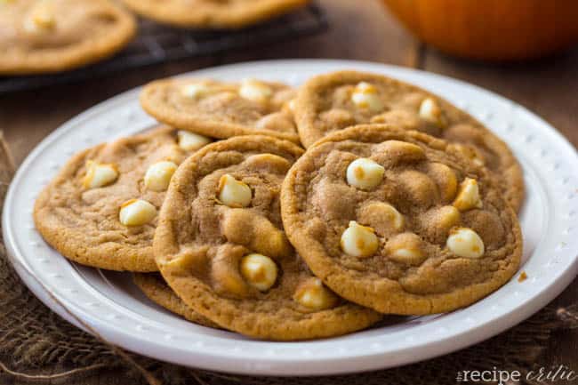 White chocolate chip pumpkin cookies on a white plate.