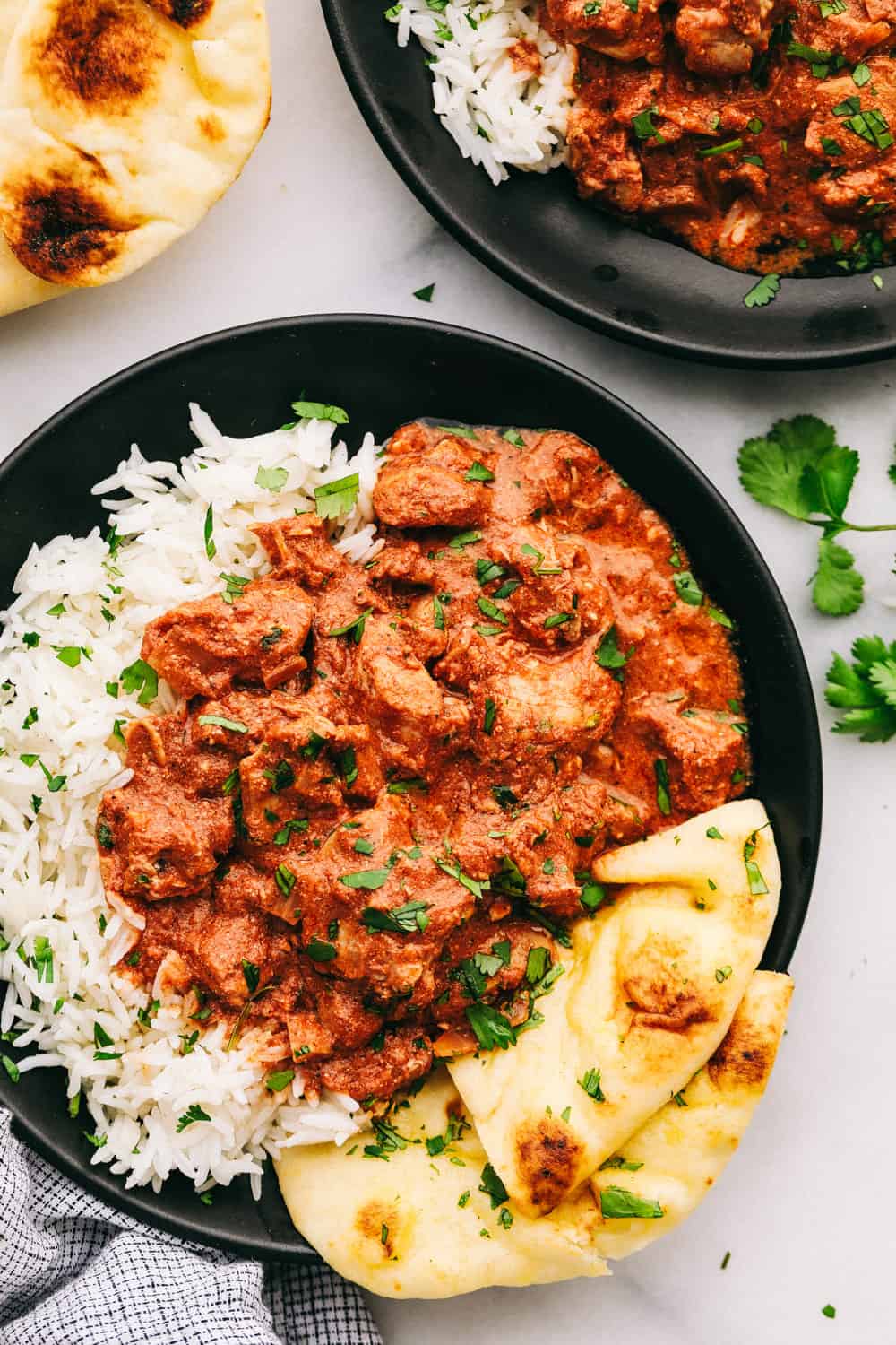 Chicken tikka masala with rice and naan bread on the side. 