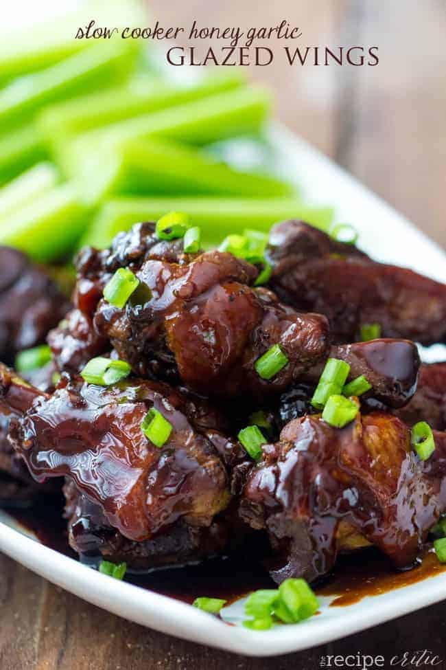 Slow cooker honey garlic glazed wings on a white plate. 