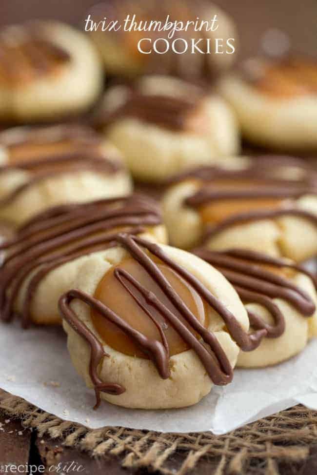 Twix thumbprint cookies on parchment paper. 