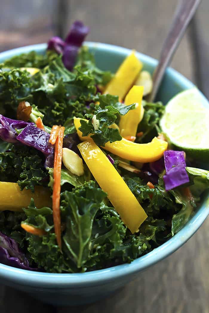 Crunchy Asian kale salad in a blue bowl.