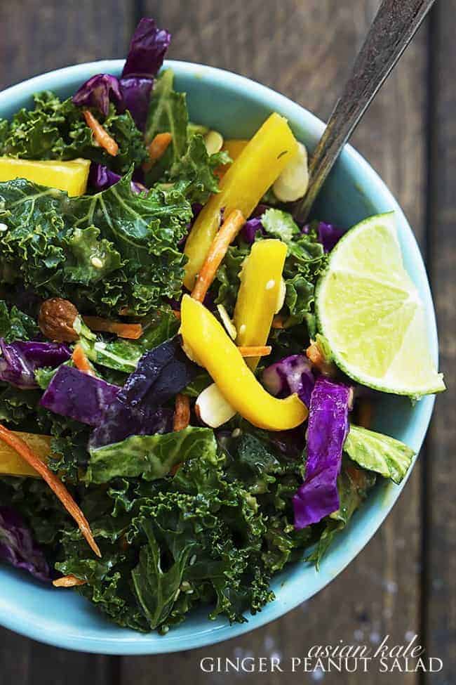 Blue bowl with asian kale thai peanut salad.