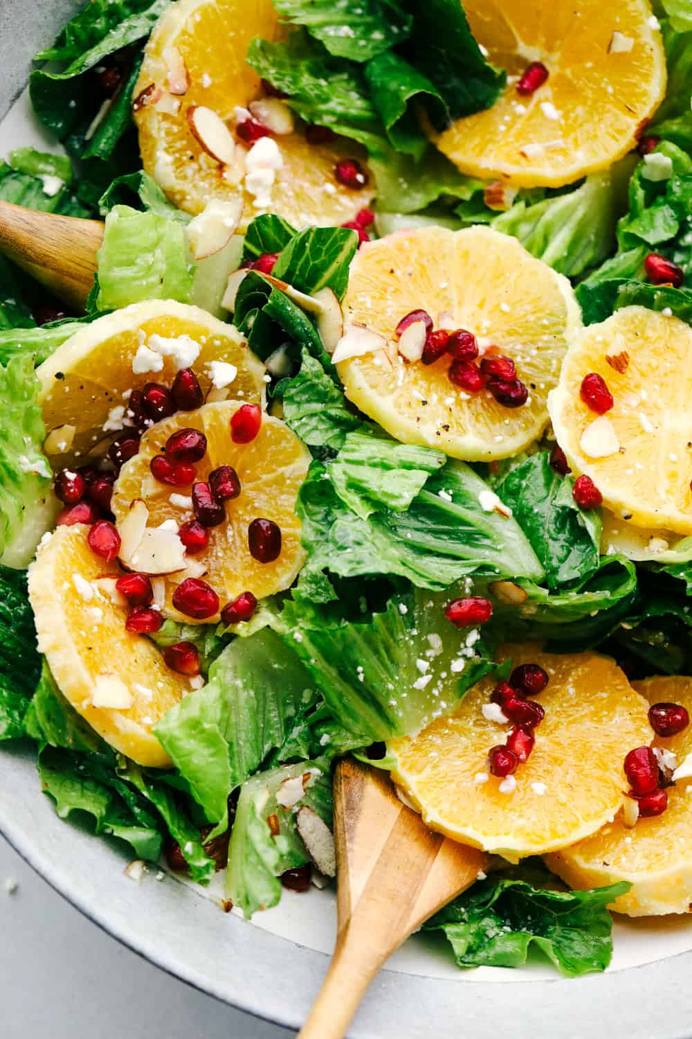 Mixing the ingredients for the Orange Pomegranate salad with Orange vinaigrette dressing.