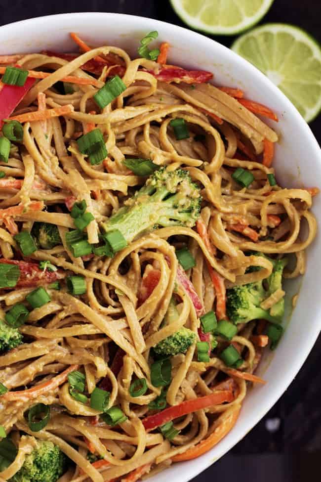 Peanut ginger noodles in a large white bowl.