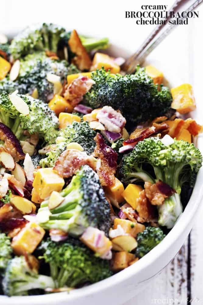 creamy broccoli salad in a white bowl.