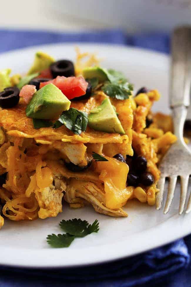 stacked enchiladas on a white plate.