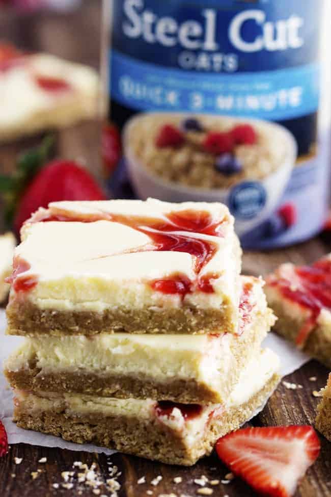 Stack of 3 strawberry swirl cheesecake bars. 