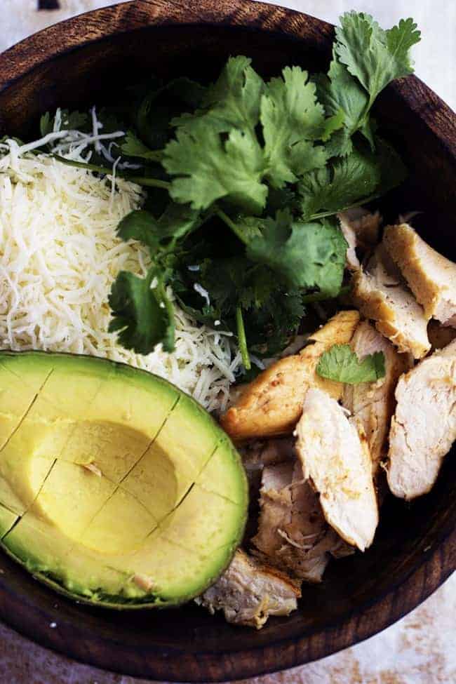 avocado burrito ingredients in a wooden bowl.