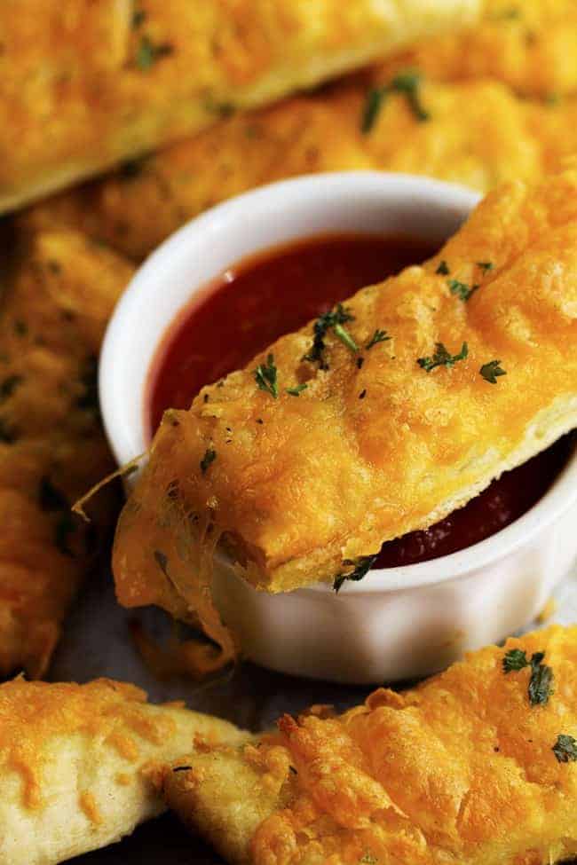 cheesy garlic stick dipping in sauce.