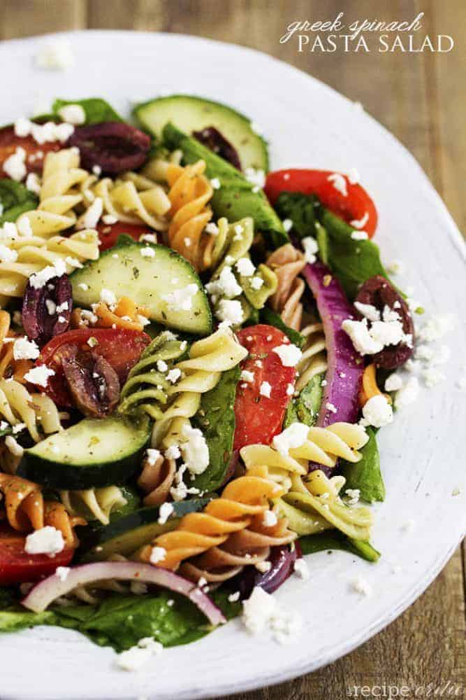 Greek spinach pasta salad on a white plate.