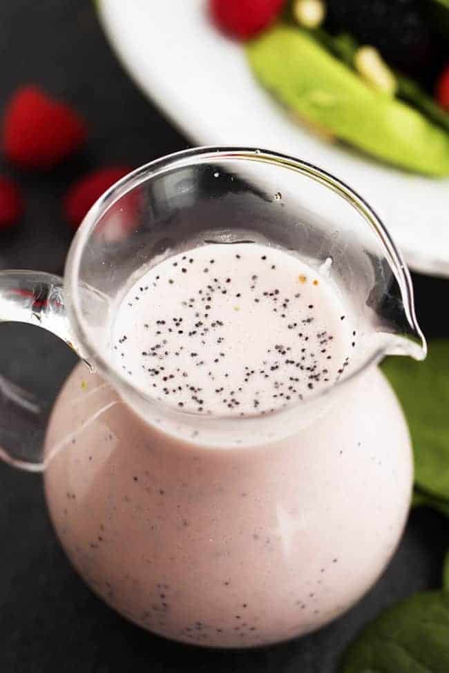 raspberry poppyseed dressing in a glass pitcher.