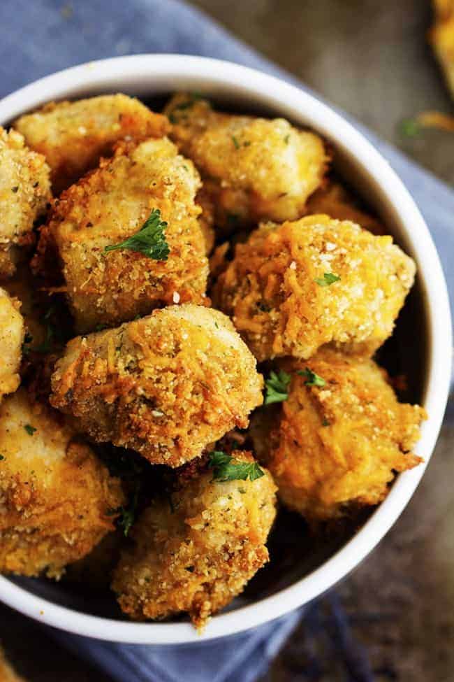 garlic parmesan cheddar chicken bites in a white bowl.