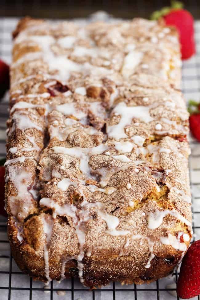 Loaf of strawberry cinnamon swirl bread on a cooling rack.