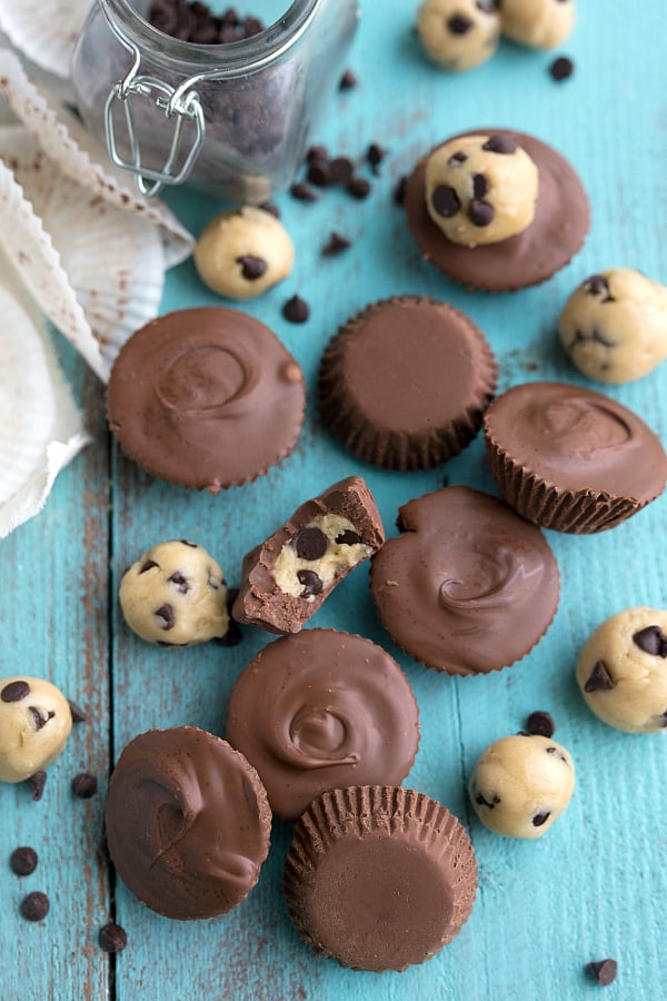 Cookie Dough Chocolate Cups on a blue table.