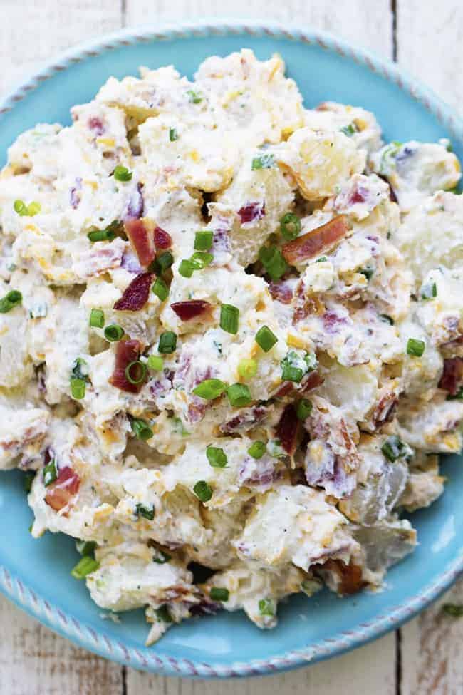 bacon ranch potato salad on a blue plate.