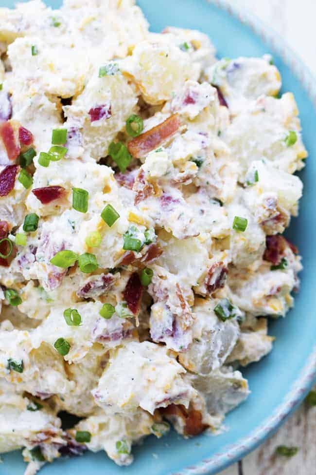 bacon ranch potato salad on a blue plate.